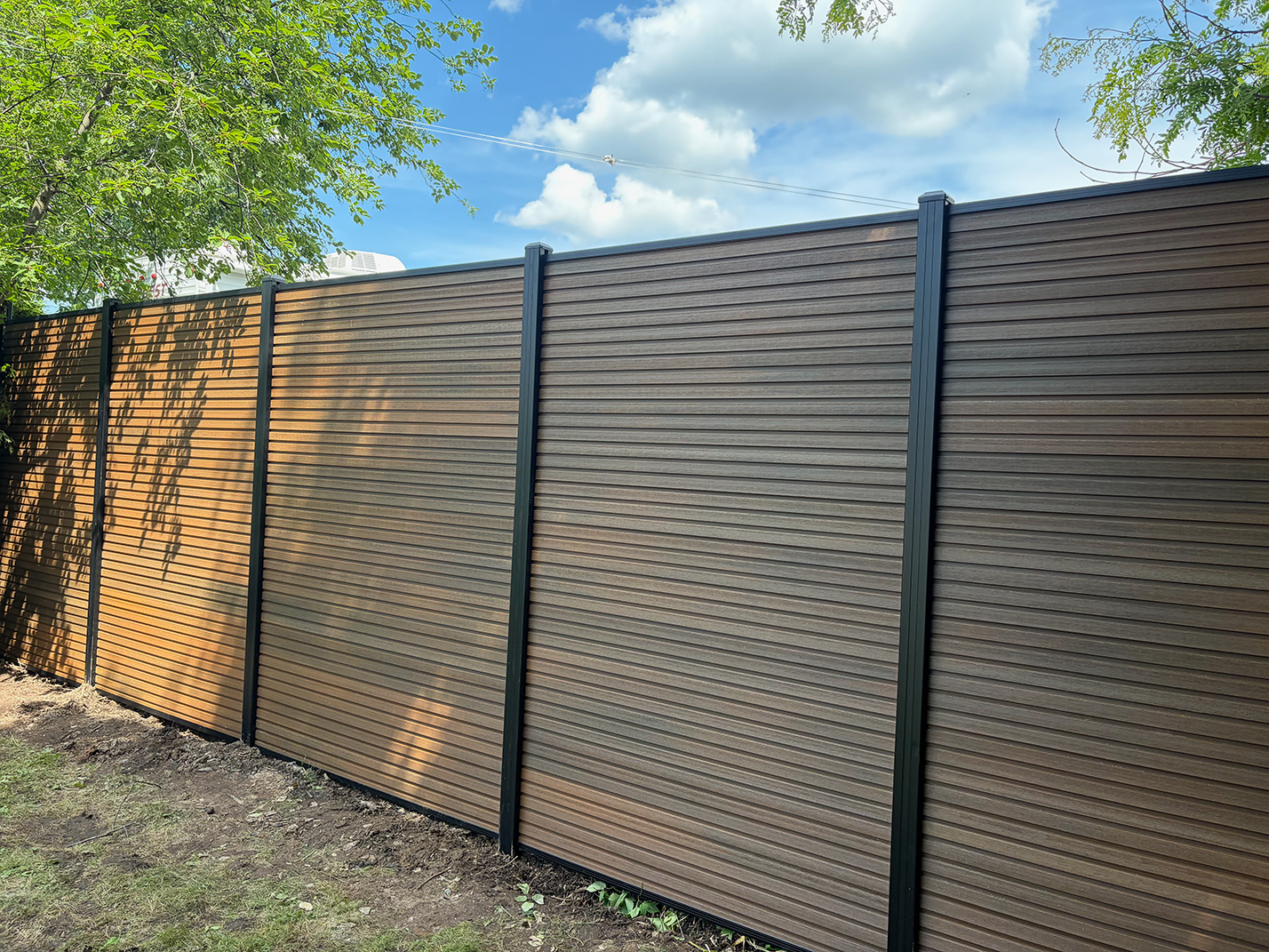 Composite privacy fence installation in Grand Montréal — Natural Brown
